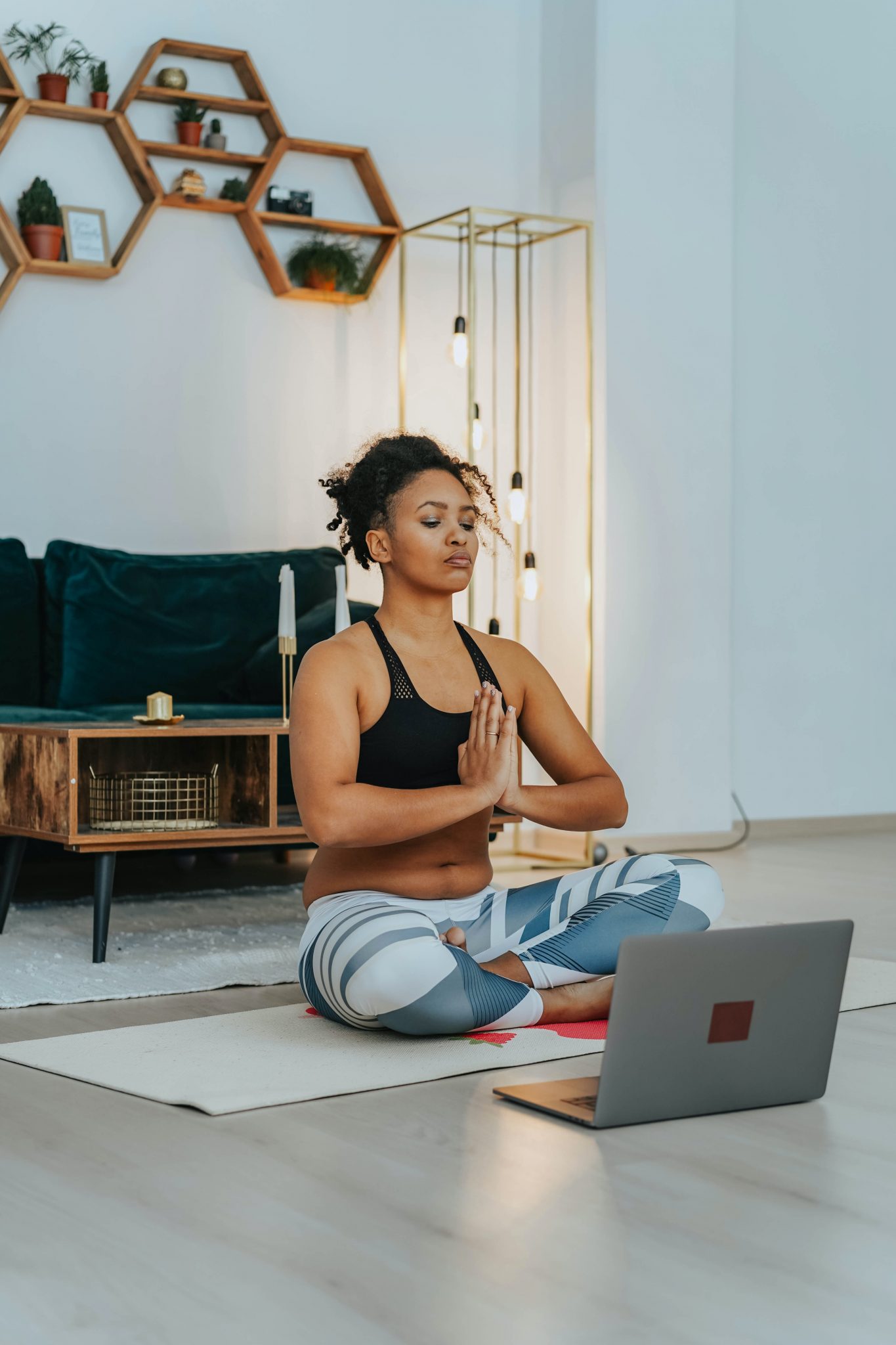 woman-doing-yoga-while-using-a-laptop